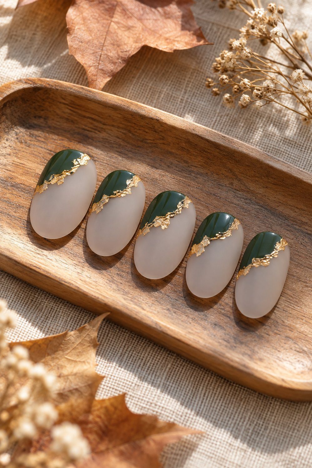 Deep green corner blocks with gold edging on matte nail tips